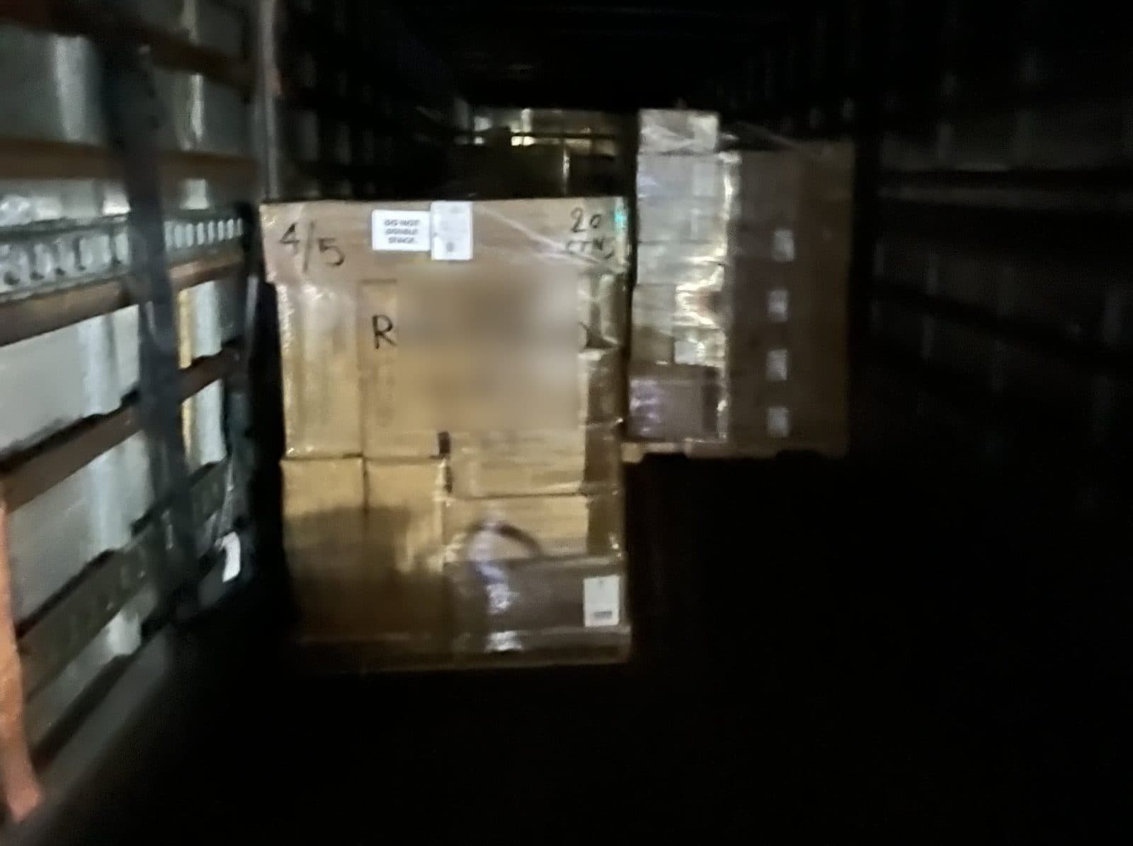 Wrapped pallet of cartons left in the dark