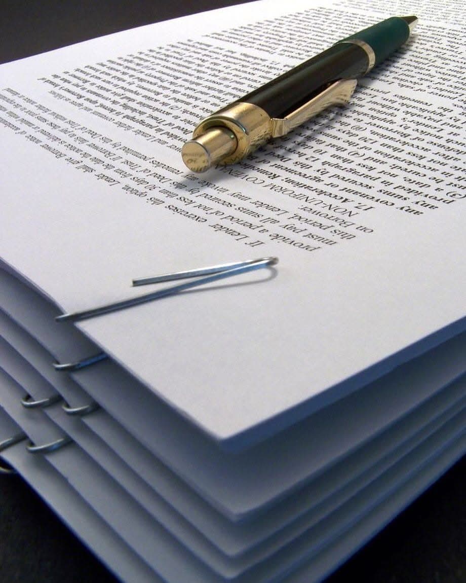 Printed document with a pen and a paper clip