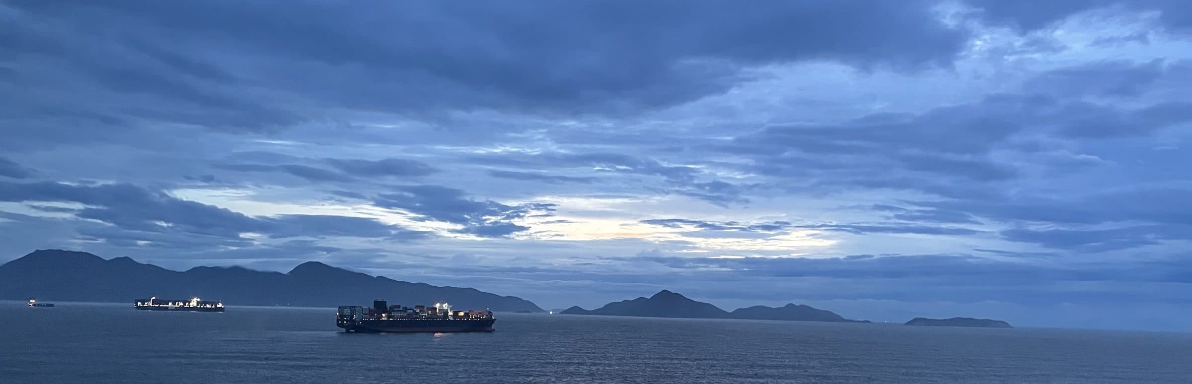 Container ships at sea at dusk