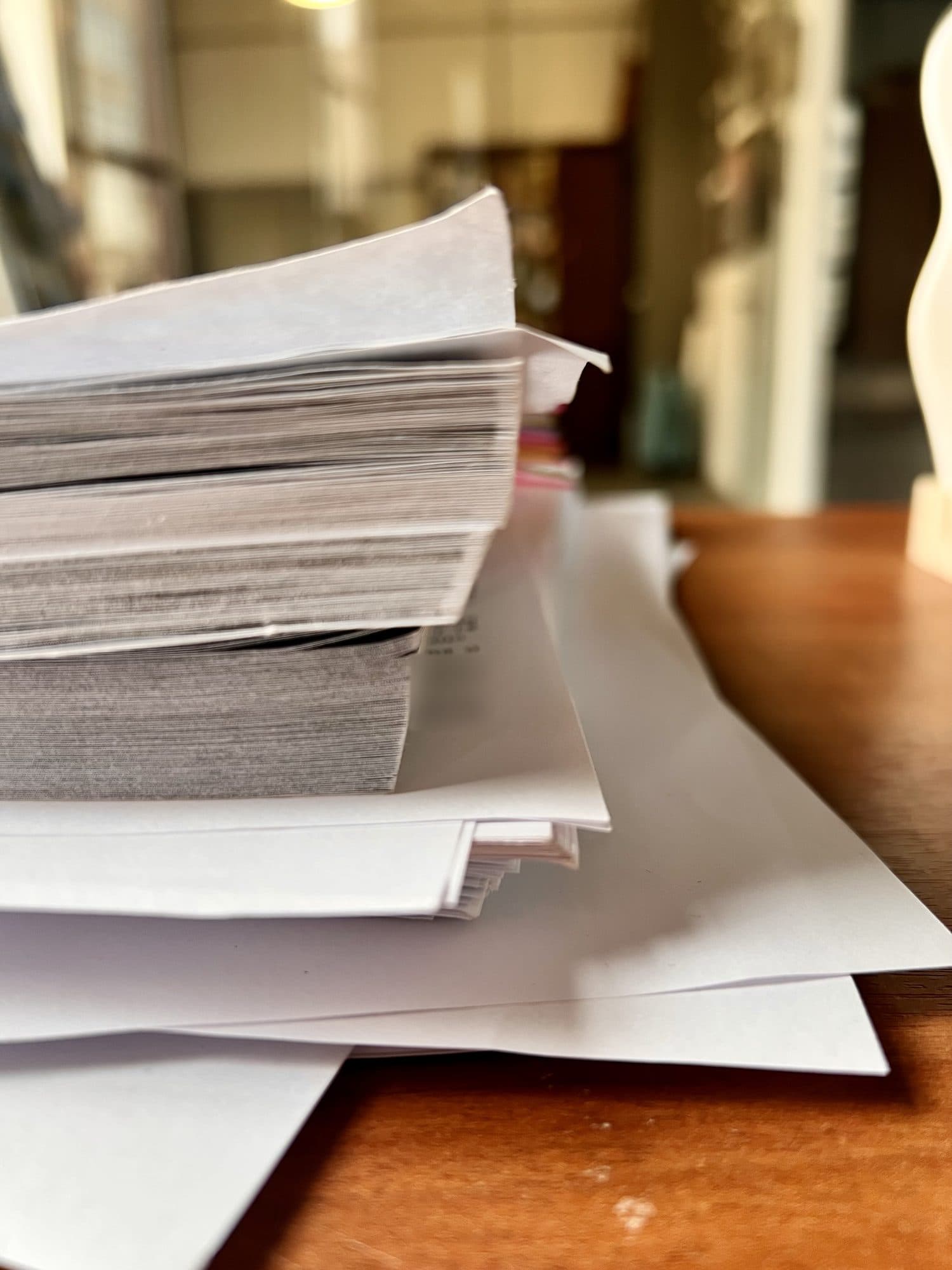 Thick stack of product documents on a desk