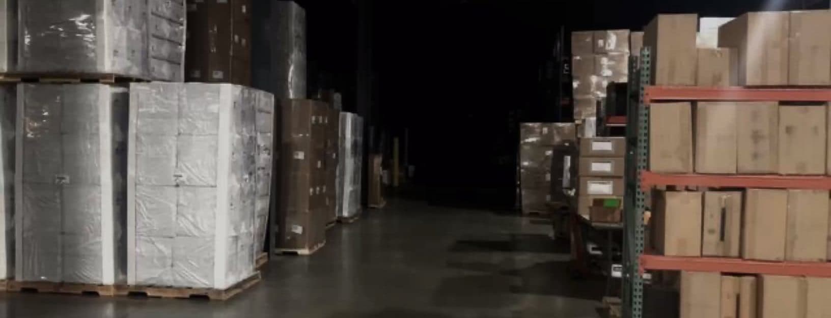 Wrapped pallets and racking in a dim warehouse